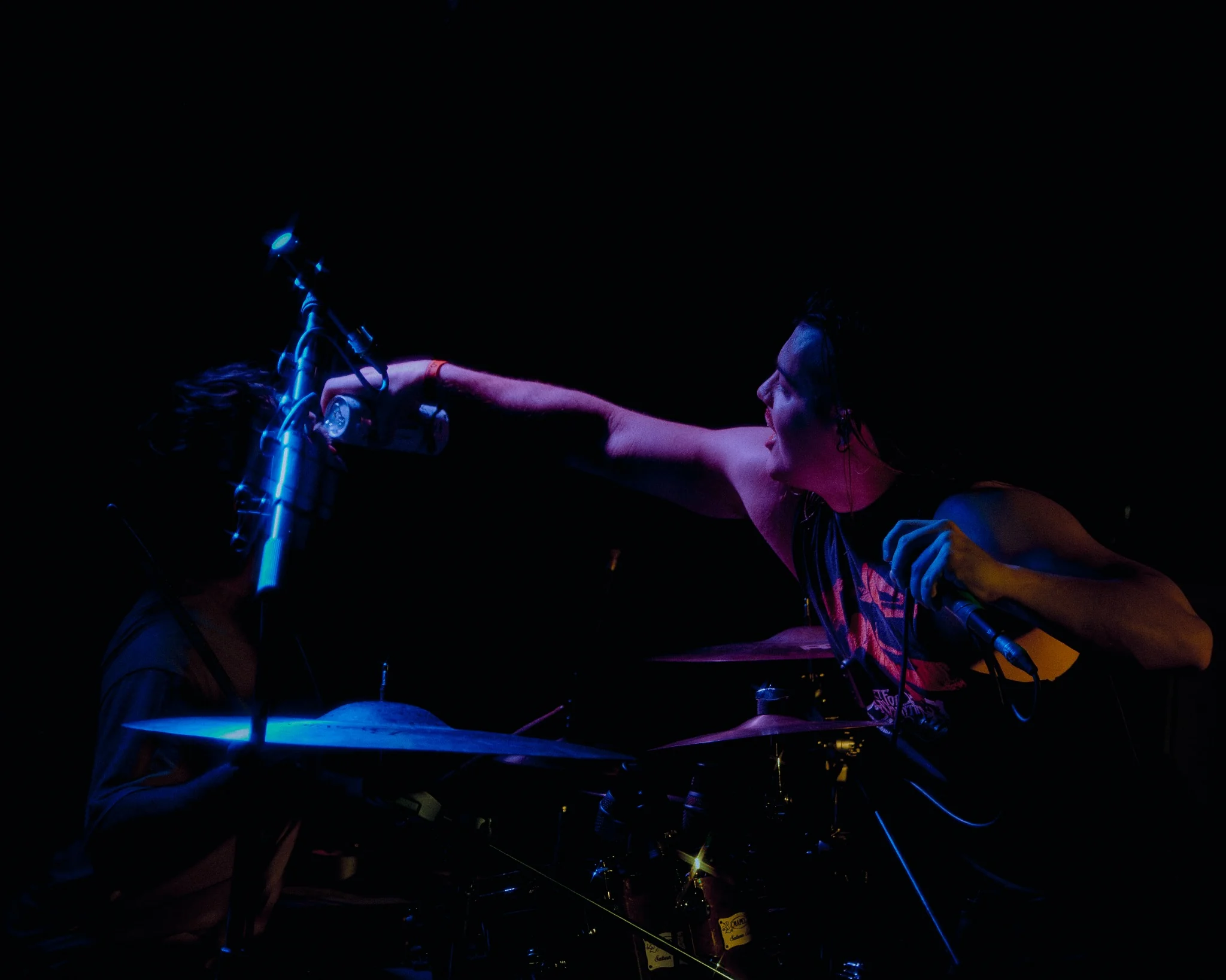Vocalist interacting with the drummer during a live performance