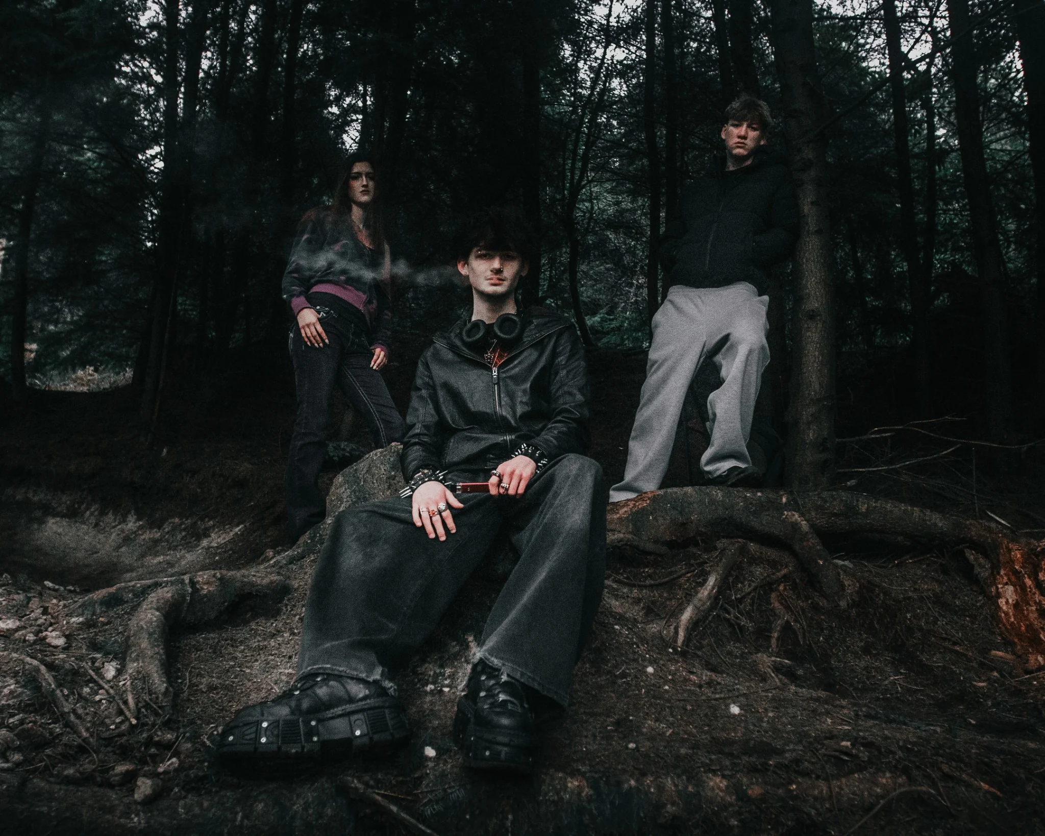Group editorial portrait in a dark woodland setting