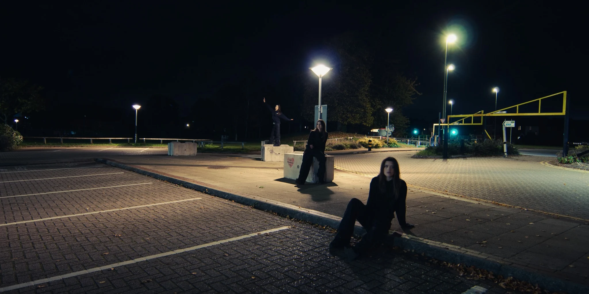 Conceptual night portrait showing repeated figures in an urban space