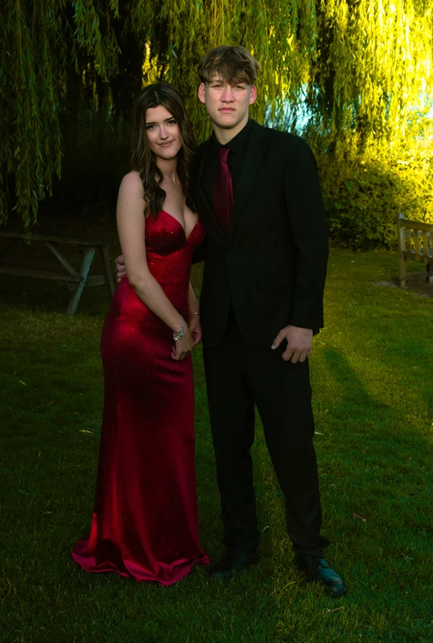 Full-length couple portrait beneath a willow tree