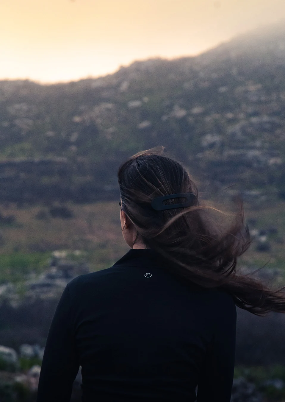Portrait in a mountainous landscape with wind and atmospheric light